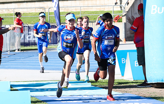 Young competitors running on track
