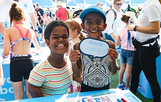 Two young children smiling for photo