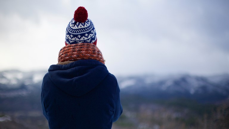 person in jumper and woolen hat