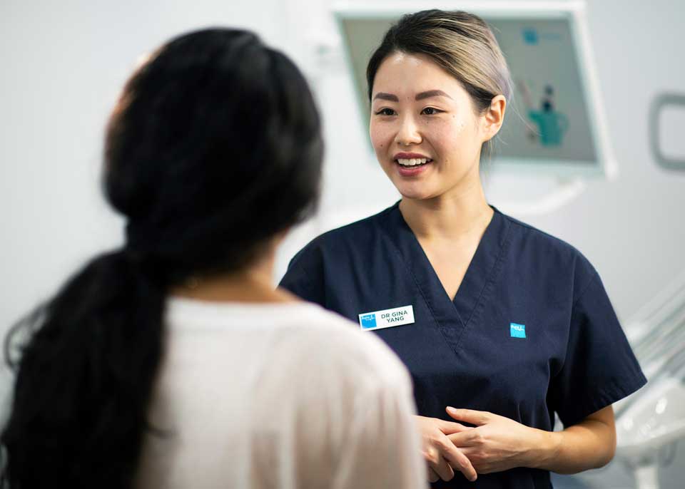 Dentist talking to patient - Bupa Dental