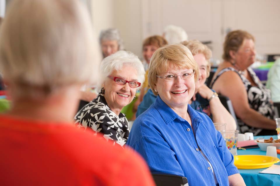 senior women listening to speaker at ladies luncheon
