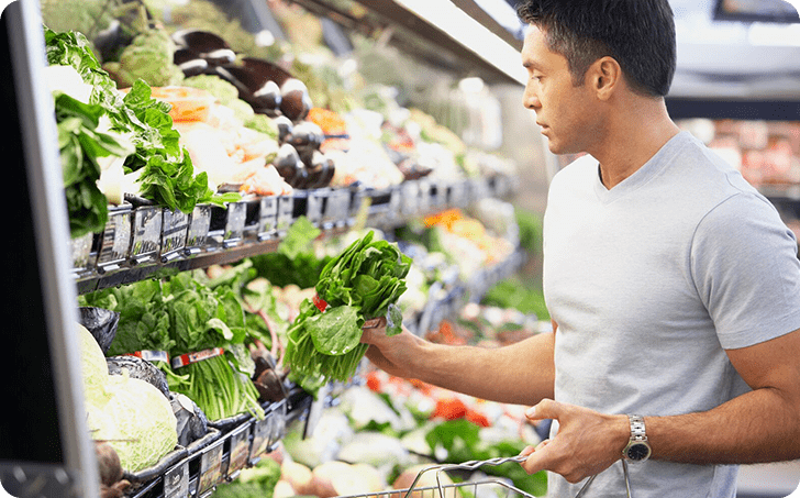 Man buying fresh produce in supermarket