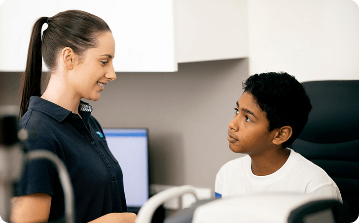 Medical professional interacting with juvenile male patient