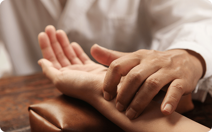 Hands of medical professional applying pressure to hands of patient