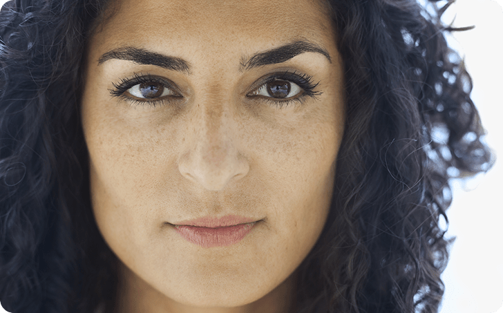 Close up of woman with dark curly hair