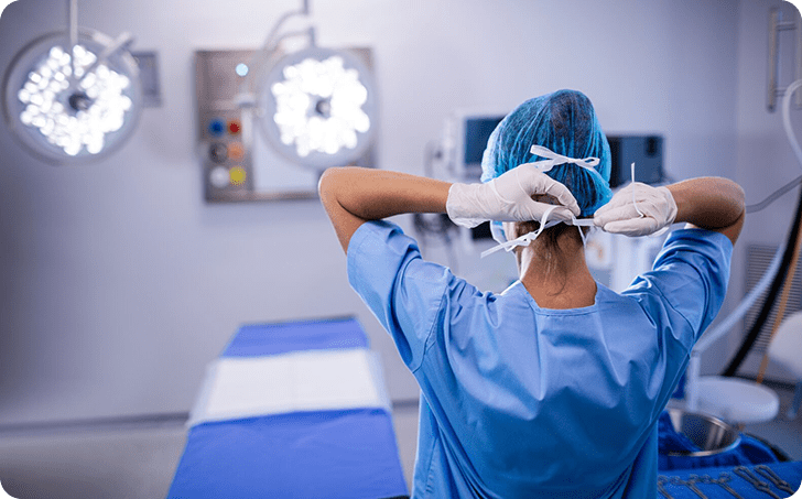 Medical professional on surgery theatre tying face mask