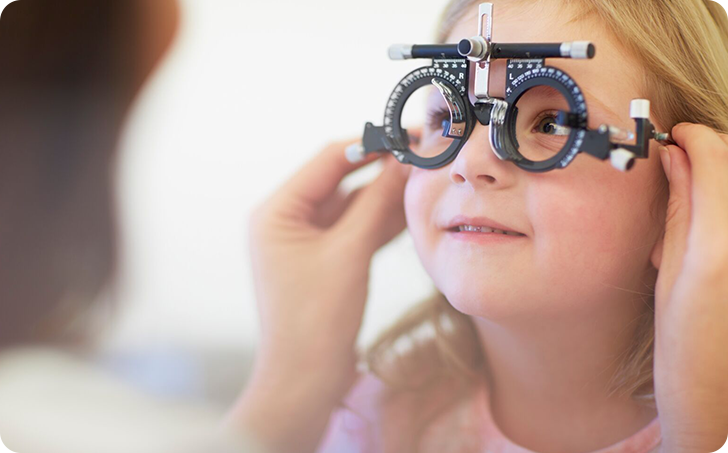 Young girl have eyes tested