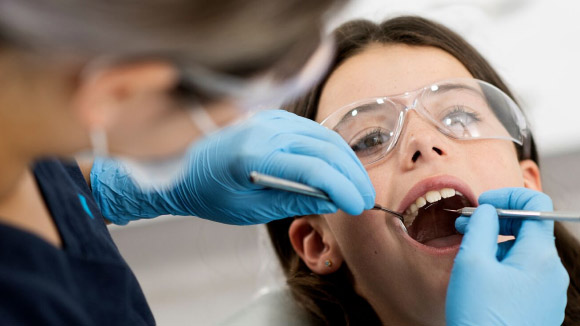 Child in dentist chair. 