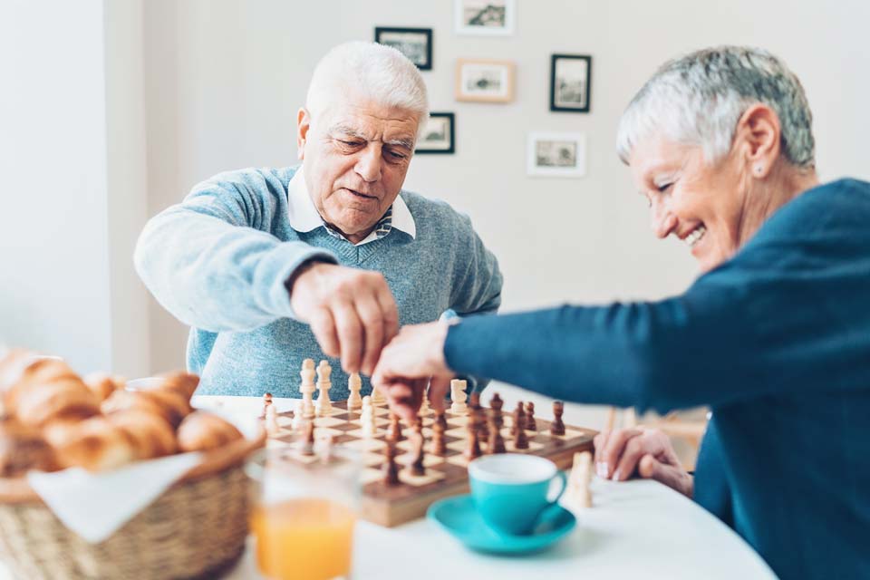 senior couple playing chess