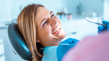 A person smiling during a dental appointment.