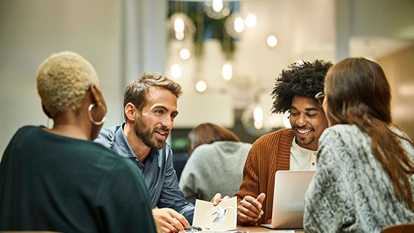 people sitting around a table and talking