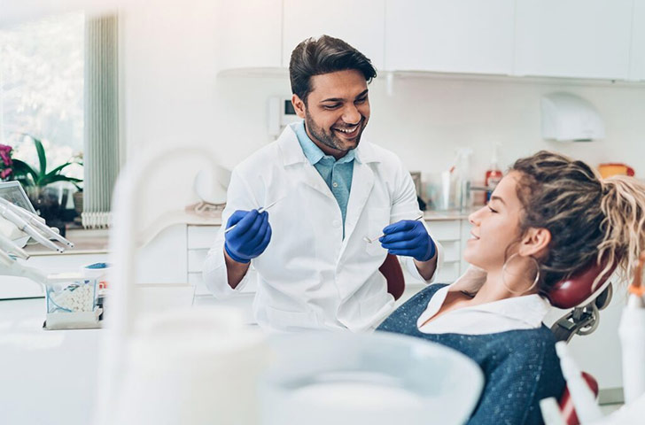 Dentist and patient in dental chair