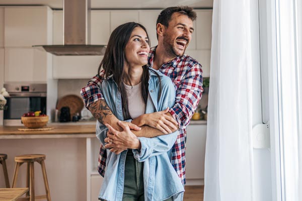 Young couple hugging in their apartment