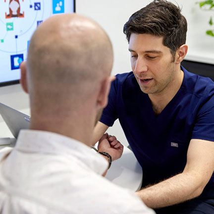 Doctor speaking to and examining patient