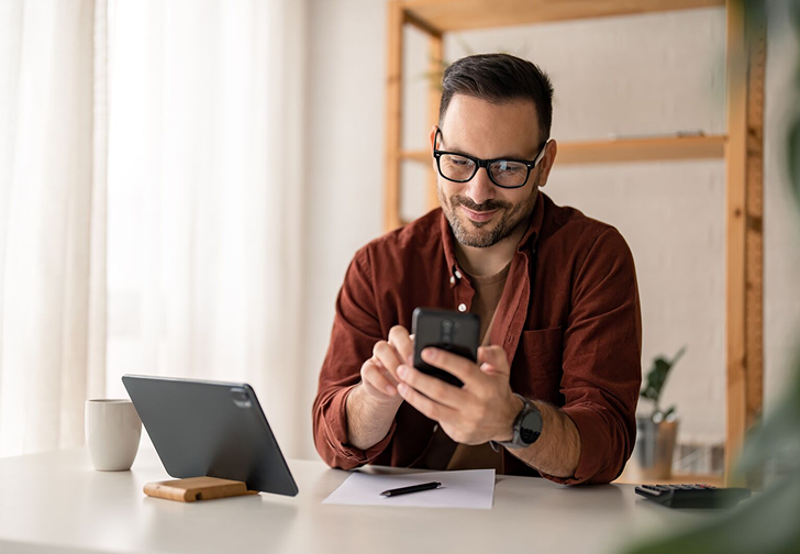 Person smiling looking at his phone